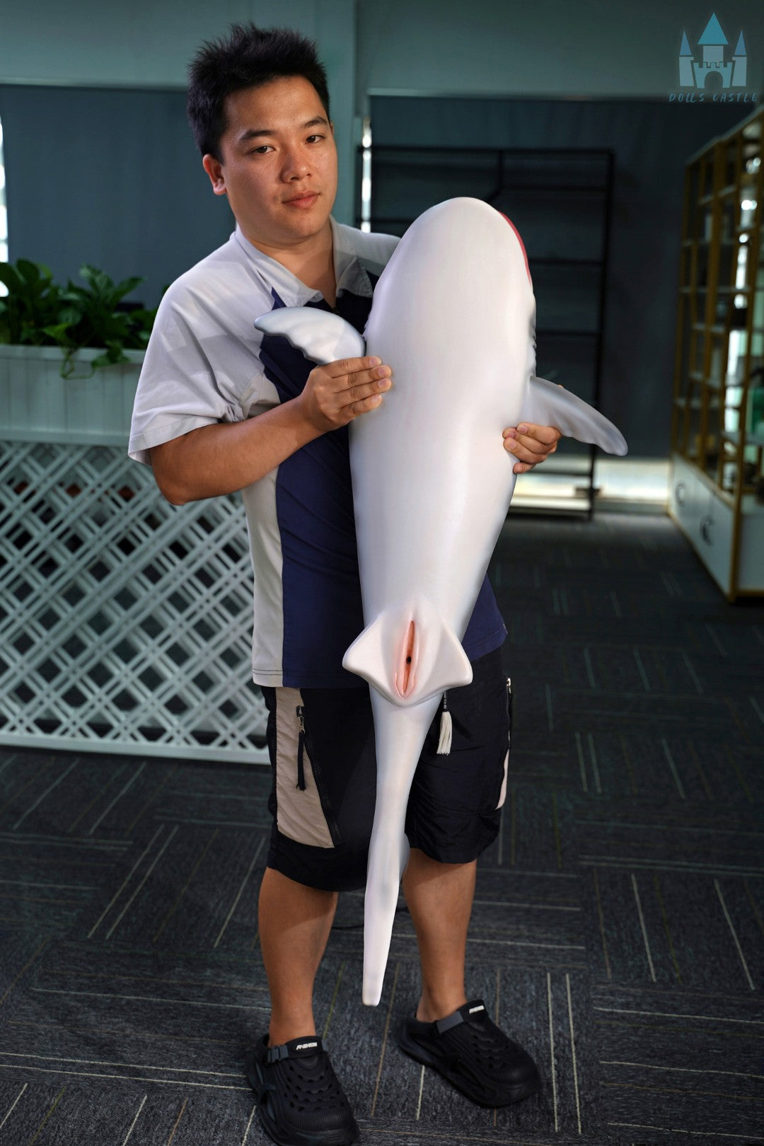 Shark Doll 110 cm is held in the arms to show size and proportions, realistic shark design with gray top and white bottom.