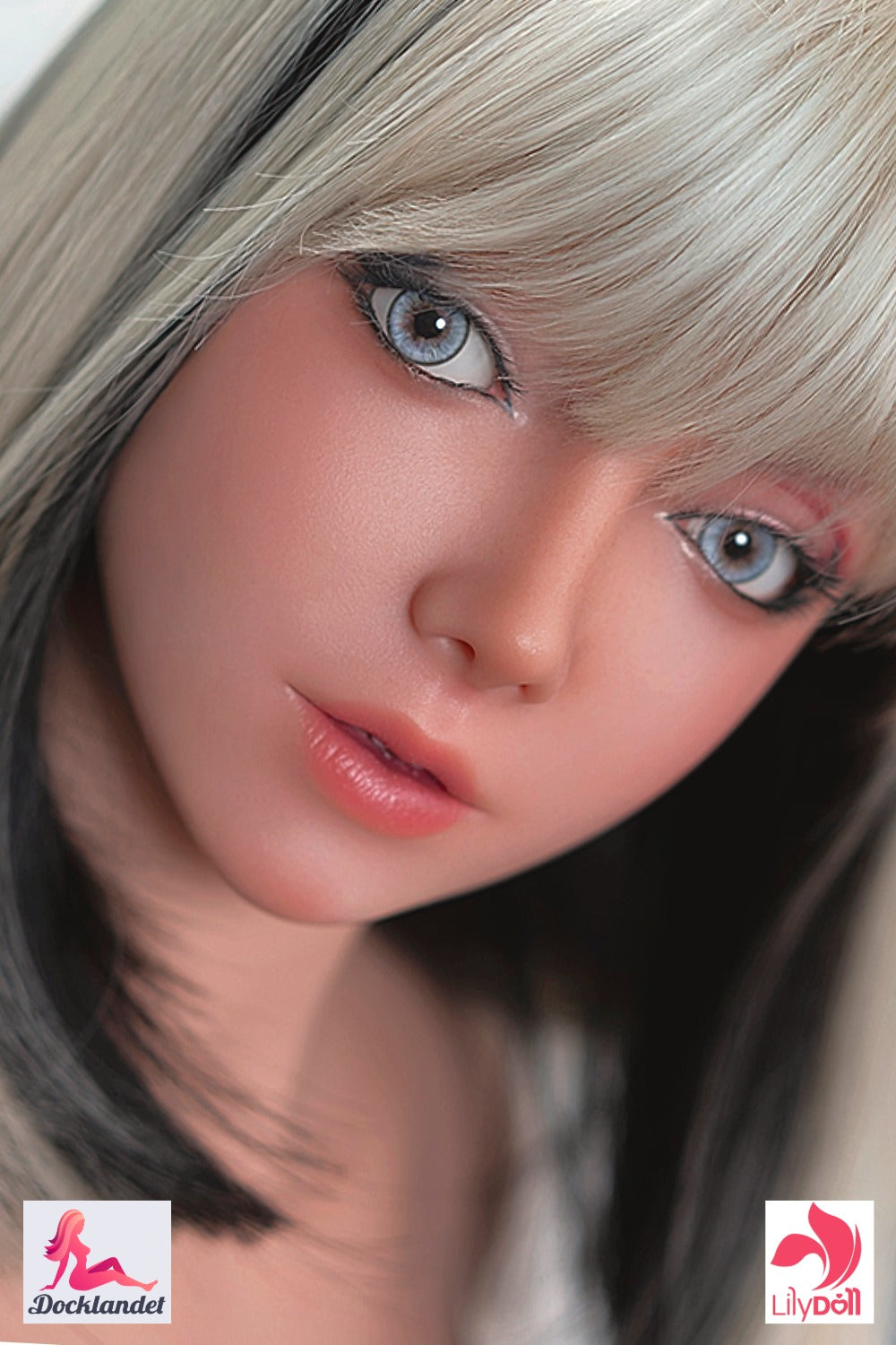 Close-up of realistic sex doll from LilyDoll with platinum-blonde hair with black highlights, big blue eyes and soft pink lips, realistic features and light skin tone